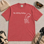 Crimson tee featuring a sad bear dressed for work and carrying a briefcase beneath the phrase “No skiing today.”