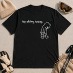 Black tee featuring a sad bear dressed for work and carrying a briefcase beneath the phrase “No skiing today.”