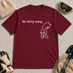 Maroon tee featuring a sad bear dressed for work and carrying a briefcase beneath the phrase “No skiing today.”