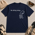 Navy tee featuring a sad bear dressed for work and carrying a briefcase beneath the phrase “No skiing today.”