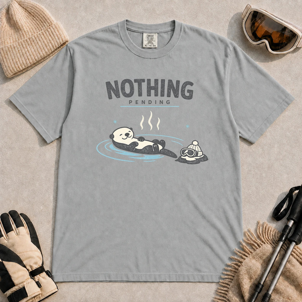 Granite tee featuring a relaxed otter soaking in a hot spring beside ski goggles and a beanie, with the phrase “Nothing Pending.”