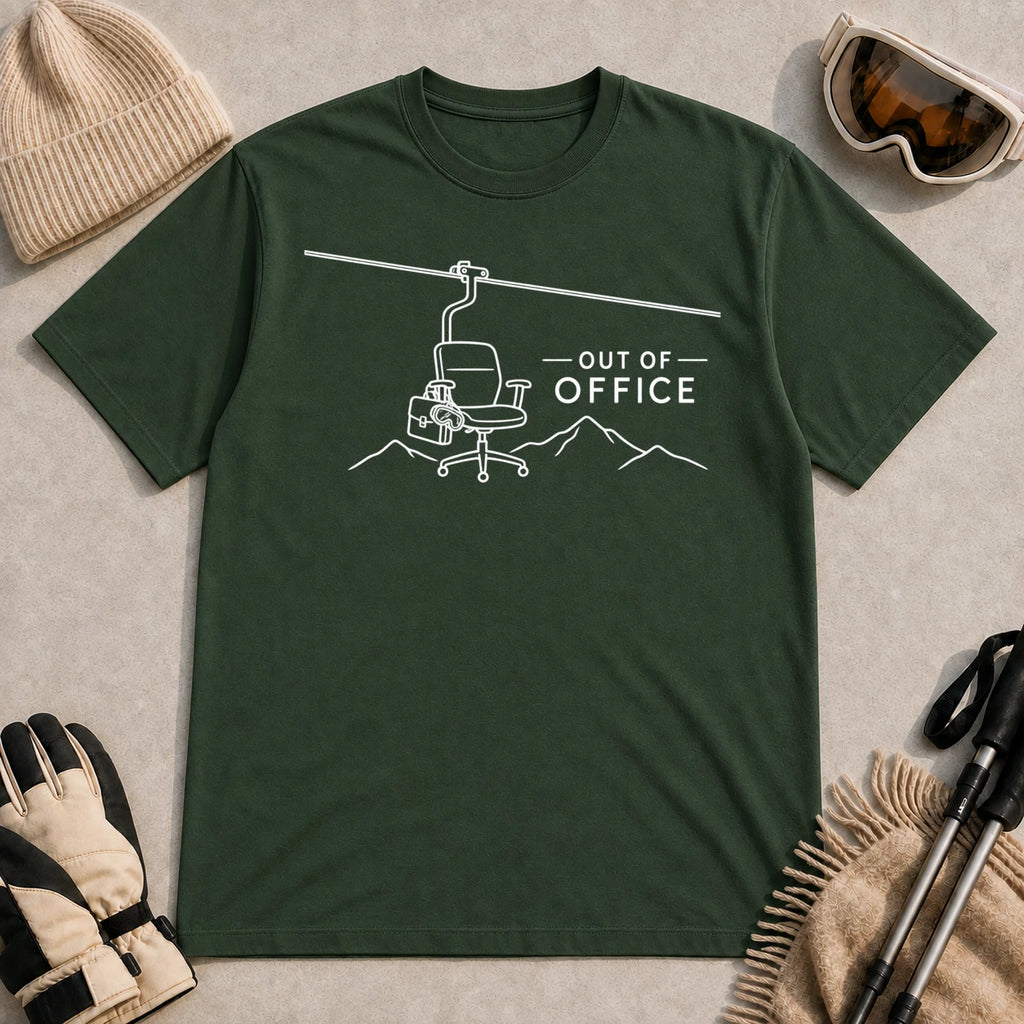 Forest Green tee featuring a minimalist white line-art chairlift carrying an office chair above mountain outlines beside the phrase “Out of Office.”