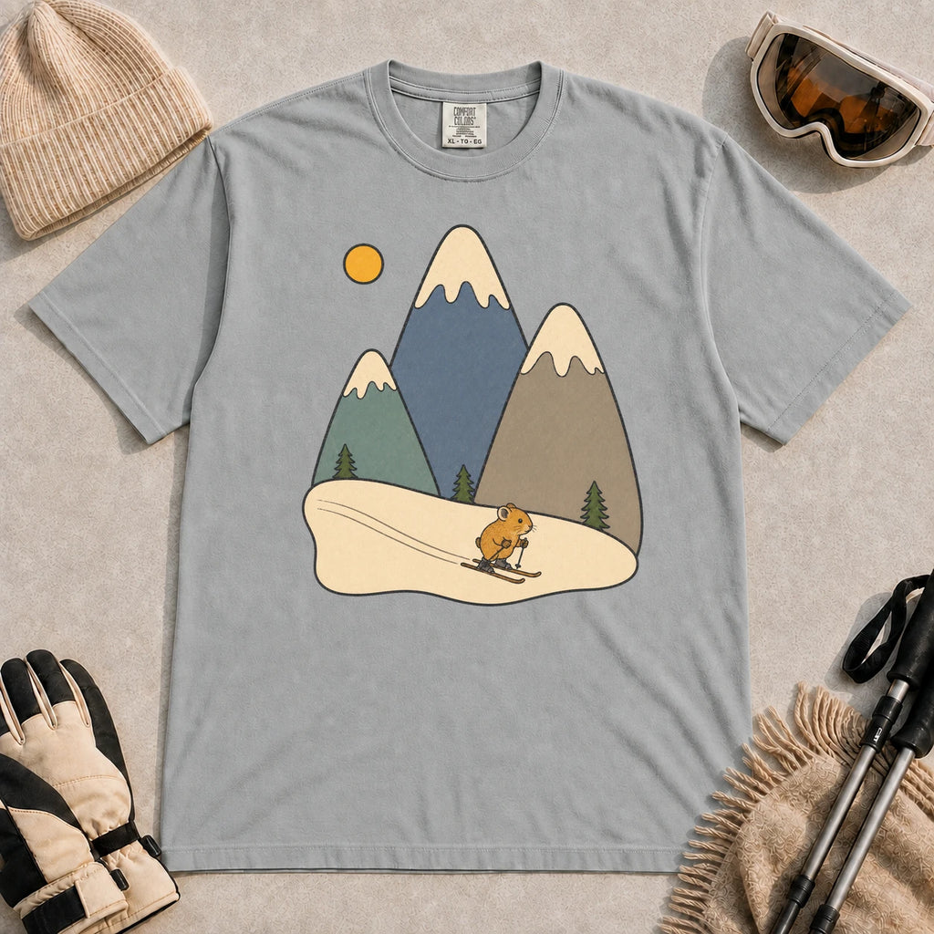 Granite tee featuring a cute pika skiing beneath stylized snow-capped mountain peaks, evergreen trees, and a golden sun.