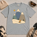 Granite tee featuring a cute pika skiing beneath stylized snow-capped mountain peaks, evergreen trees, and a golden sun.