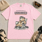 Blossom tee featuring a relaxed beaver in ski goggles sitting in a chair with a hot drink, with the phrase “Professionally Unhurried.”