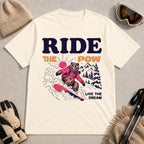 Natural tee featuring a bear snowboarding through powder in a retro mountain scene with the phrases “Ride the Pow” and “Live the Dream.”