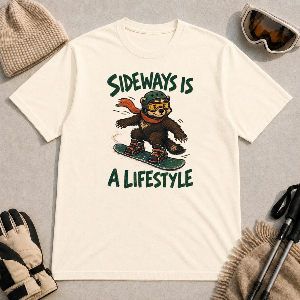 Natural tee featuring a bear in snowboard gear carving sideways through the snow with the phrase “Sideways Is a Lifestyle.”