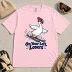 Blossom tee featuring a playful goose skiing in goggles and a beanie above the phrase “On Your Left, Losers.”