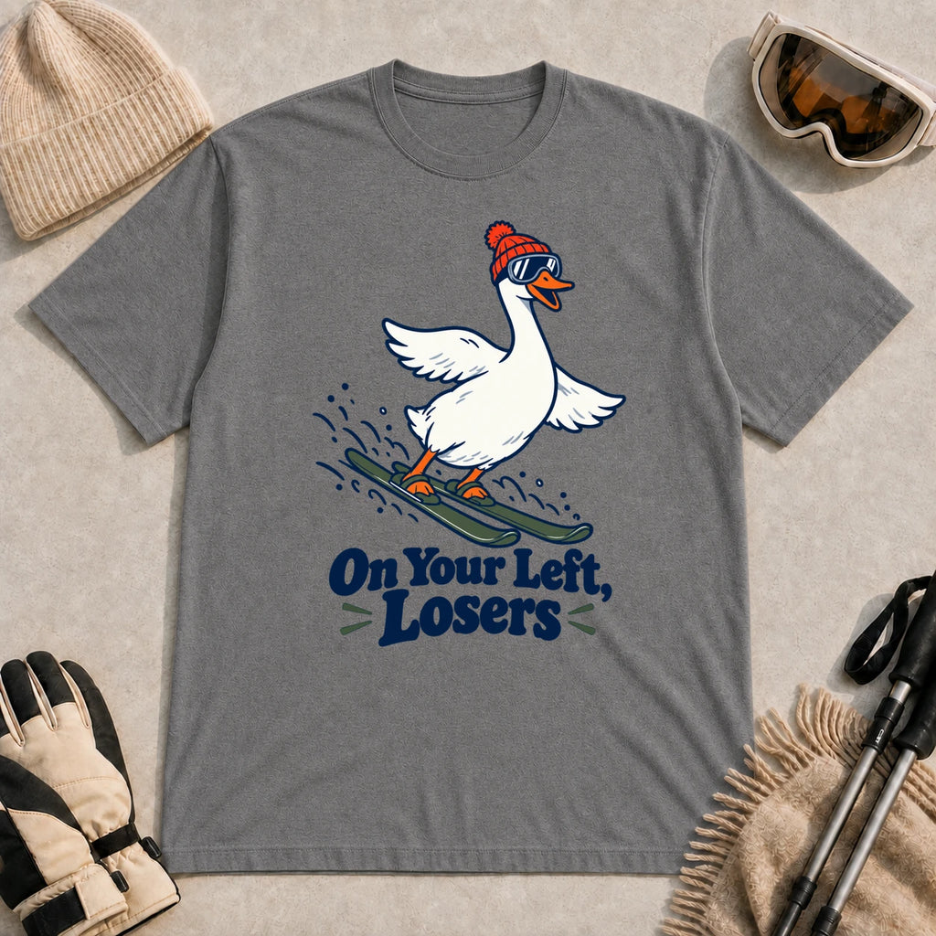 Graphite Heather tee featuring a playful goose skiing in goggles and a beanie above the phrase “On Your Left, Losers.”