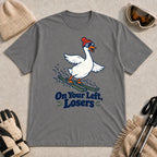 Graphite Heather tee featuring a playful goose skiing in goggles and a beanie above the phrase “On Your Left, Losers.”