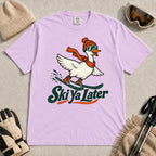 Orchid tee featuring a playful goose skiing in goggles and a beanie above the phrase “On Your Left, Losers.”