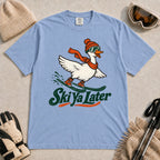 Washed Denim tee featuring a playful goose skiing in goggles and a beanie above the phrase “On Your Left, Losers.”