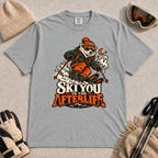 Granite tee featuring a polar bear skiing through a spooky Halloween scene with a ghost and crescent moon above the phrase “Ski You in the Afterlife.”