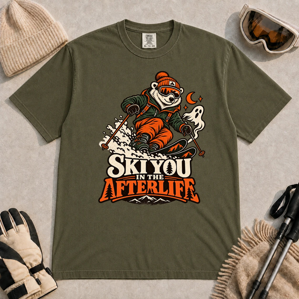 Hemp tee featuring a polar bear skiing through a spooky Halloween scene with a ghost and crescent moon above the phrase “Ski You in the Afterlife.”