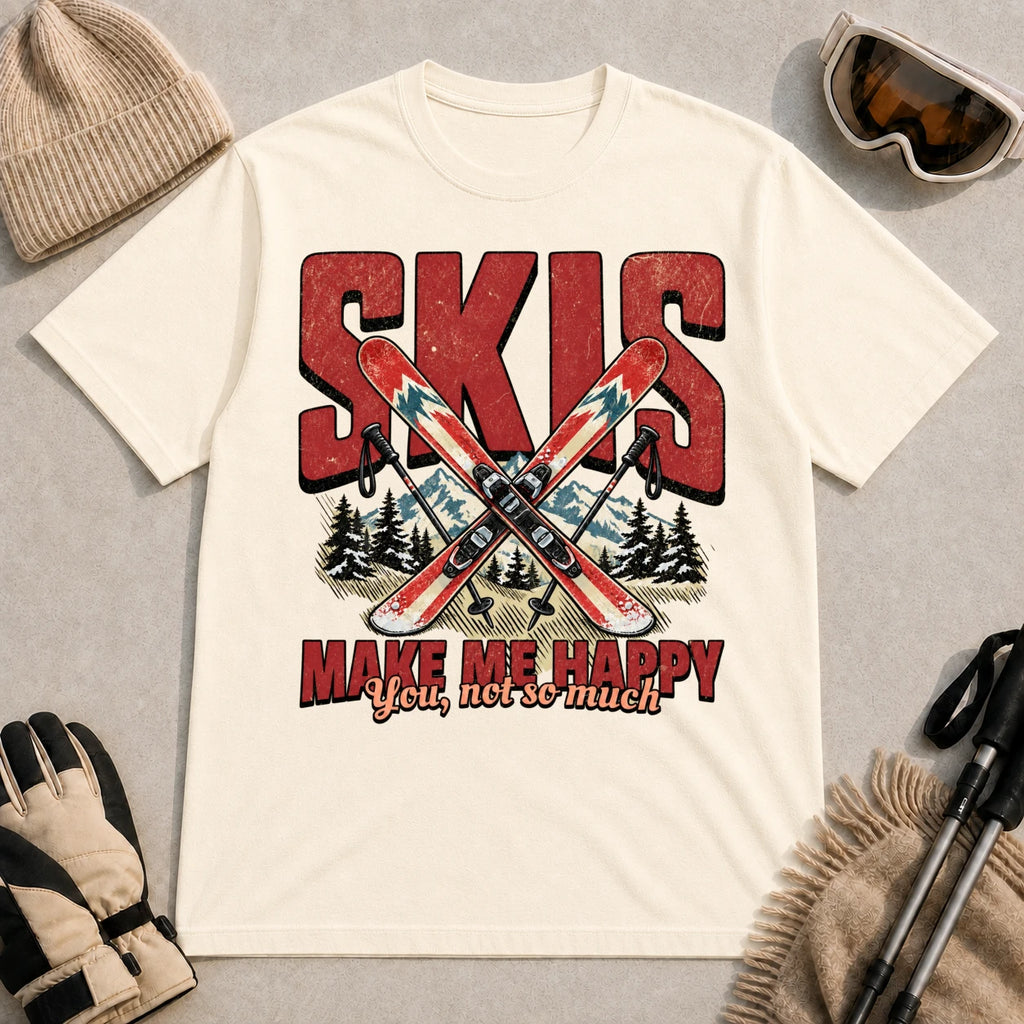 Natural tee featuring crossed skis and poles in front of bold retro “Skis” lettering with the phrase “Make Me Happy, You Not So Much.”