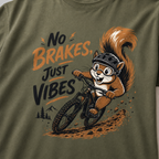 Close-up of a hemp green t-shirt featuring a helmeted squirrel riding a mountain bike with “No Brakes, Just Vibes” text.