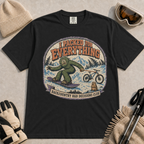 Black t-shirt featuring a vintage Bigfoot snowboarding through the mountains with a mountain bike and marmot, with the phrases “I Packed for Everything” and “Backcountry Bad Decisions Club.”