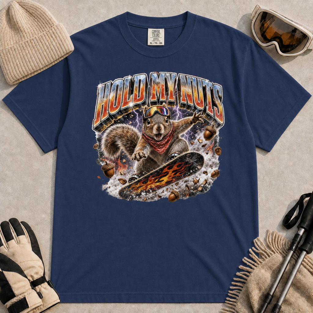 Navy tee featuring a retro “Hold My Nuts” snowboarding squirrel graphic with flying acorns, lightning, and bold metallic lettering.