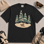 Black t-shirt featuring a playful beaver snowboarding across a cream-coloured snowy clearing beneath a cluster of snow-covered pine trees.