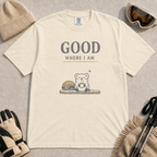 Ivory tee featuring a small polar bear holding a warm mug beside ski goggles, with the phrase “Good Where I Am.”