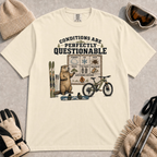 Ivory tee featuring a marmot presenting a questionable conditions chart beside skis, a snowboard and a mountain bike, with “Conditions Are Perfectly Questionable” text.