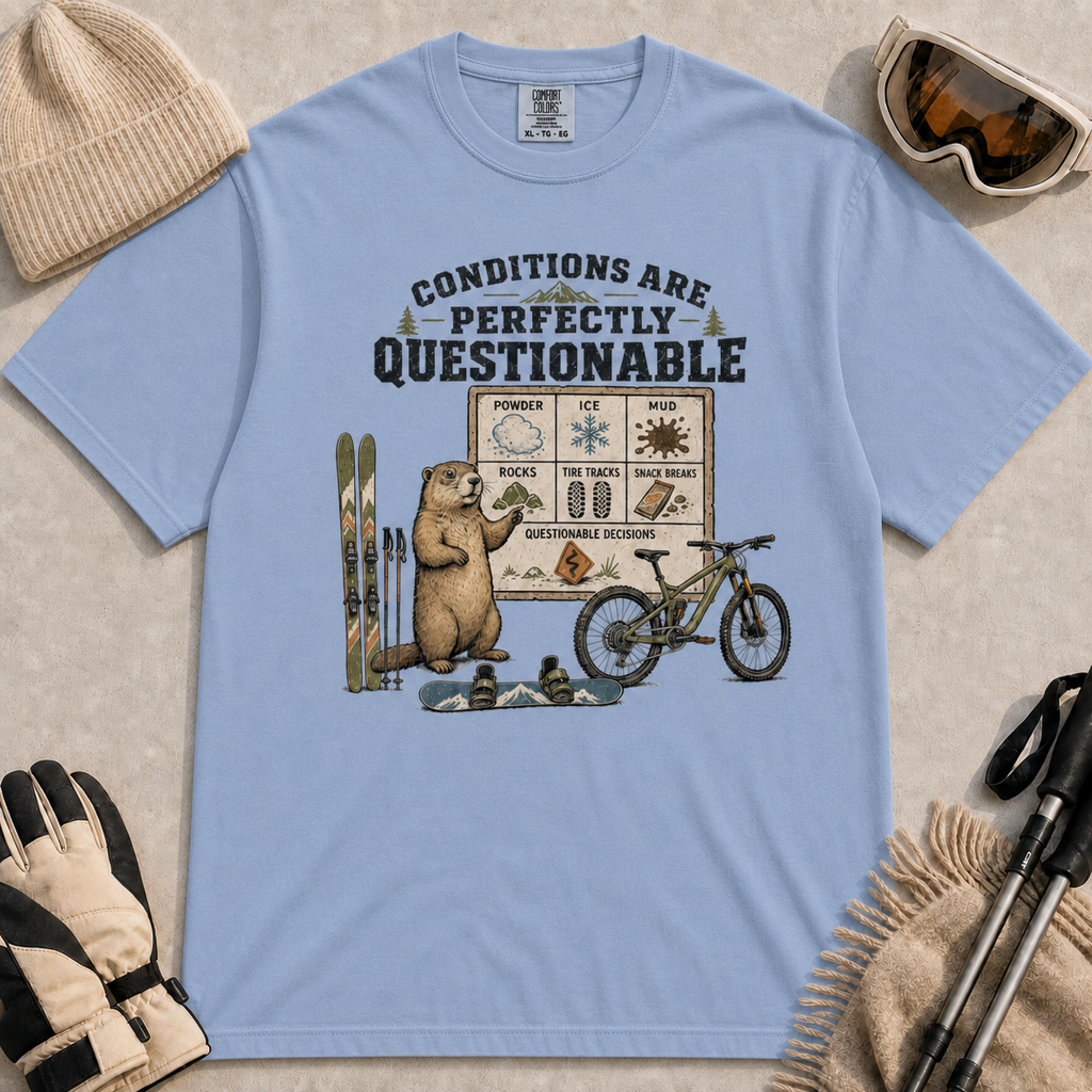 Washed denim tee featuring a marmot presenting a questionable conditions chart beside skis, a snowboard and a mountain bike, with “Conditions Are Perfectly Questionable” text.
