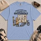 Washed denim tee featuring a marmot presenting a questionable conditions chart beside skis, a snowboard and a mountain bike, with “Conditions Are Perfectly Questionable” text.