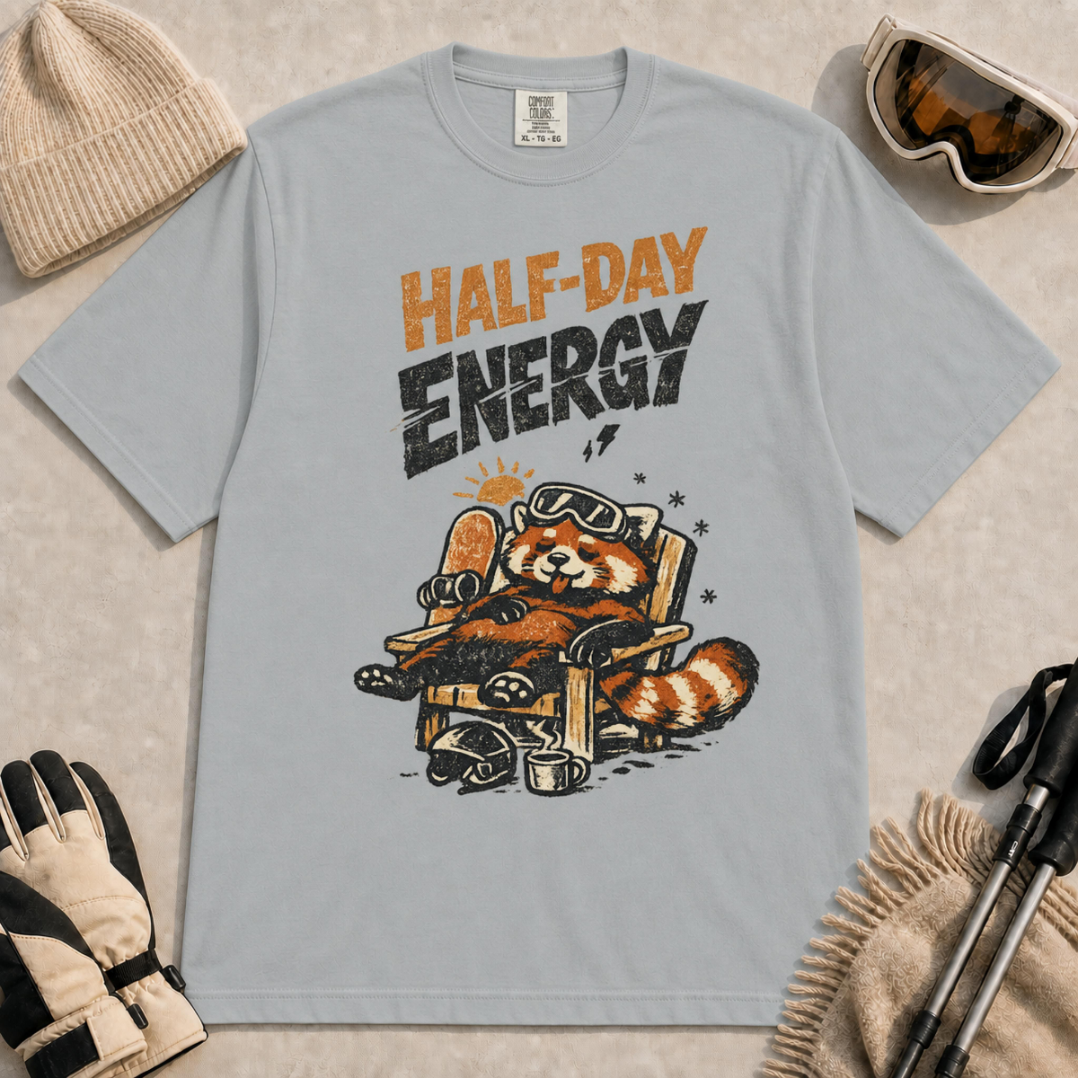 Granite tee featuring a relaxed red panda lounging in a chair with snowboard gear and the phrase “Half-Day Energy.”