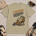 Khaki t-shirt featuring a vintage sloth wearing ski goggles and relaxing in a rocking chair with a hot drink, with the phrase “Low-Speed Lifestyle.”