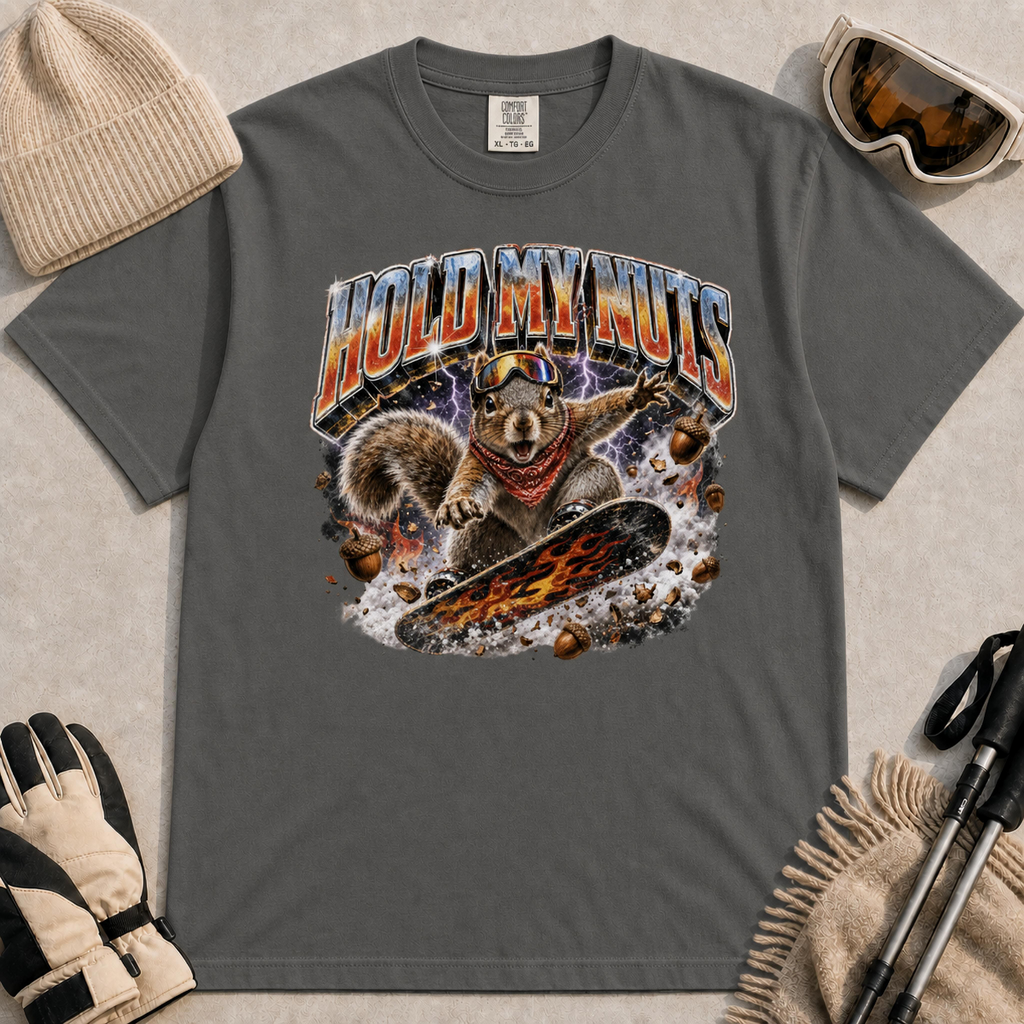 Pepper tee featuring a retro “Hold My Nuts” snowboarding squirrel graphic with flying acorns, lightning, and bold metallic lettering.