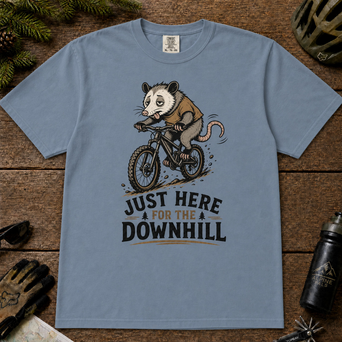 Blue Jean t-shirt featuring a vintage opossum riding a mountain bike downhill, with the phrase “Just Here for the Downhill.”