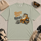 Bay green t-shirt featuring a relaxed marmot in ski goggles lounging on a wooden chair with a steaming mug, ski boots, helmet and snowboard beside the phrase “Boots Off, Brain Off.”
