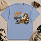 Washed Denim t-shirt featuring a relaxed beaver in ski goggles lounging on a wooden chair with a steaming mug, ski boots, helmet and snowboard beside the phrase “Boots Off, Brain Off.”