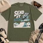 Hemp green t-shirt with a graphic design of a snowboarding wolf and text 'Send It Society' on a beige surface with winter accessories.