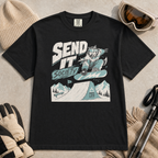 Black t-shirt with a graphic design of a snowboarding wolf and text 'Send It Society' on a beige surface with winter accessories.