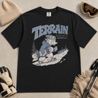 Black t-shirt with 'Terrain Addict' graphic on a light gray surface with winter accessories.