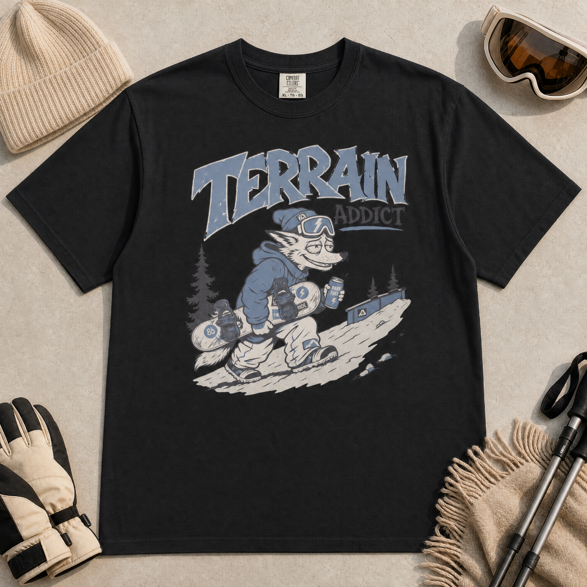 Black t-shirt with 'Terrain Addict' graphic on a light gray surface with winter accessories.