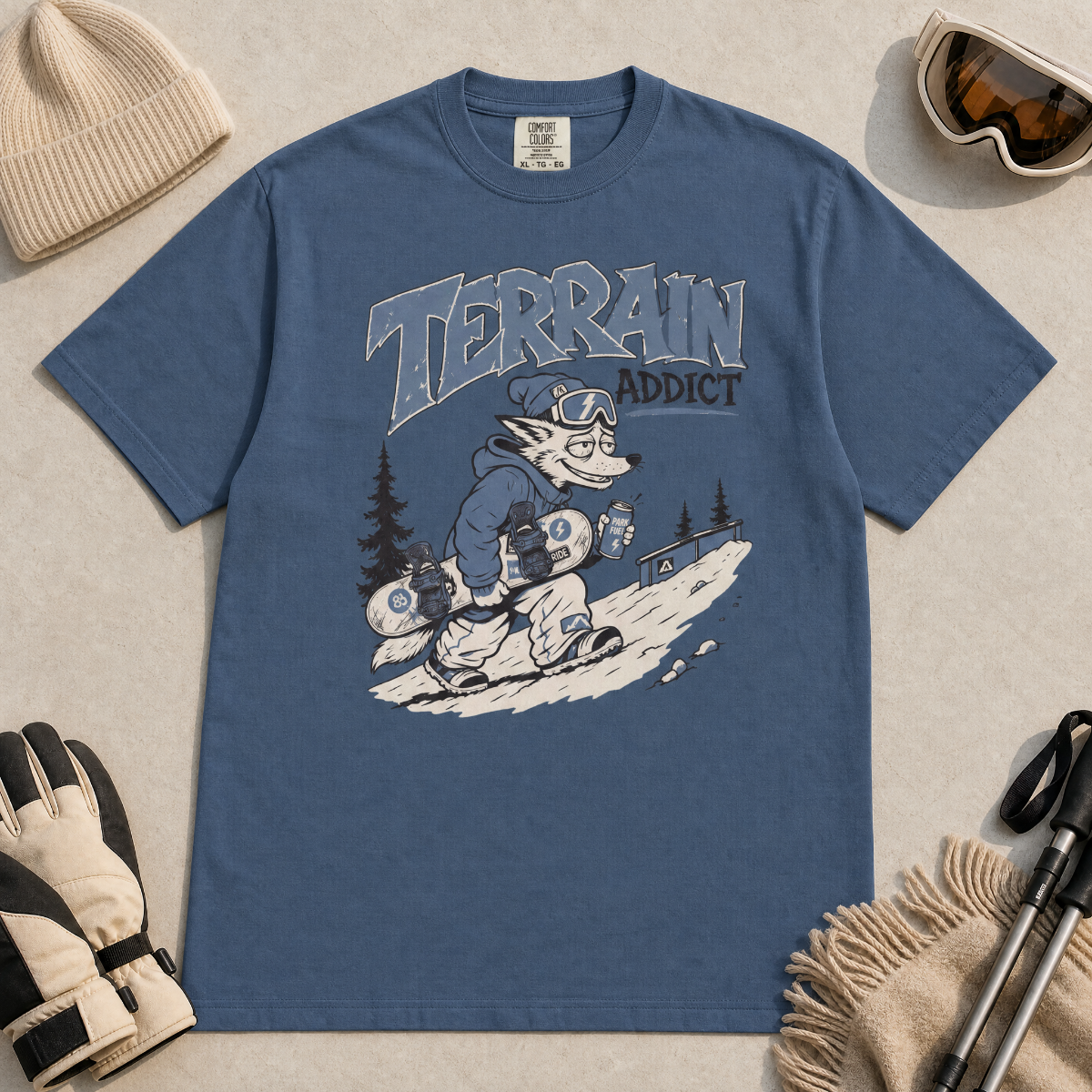 Midnight blue t-shirt with 'Terrain Addict' graphic on a light gray surface with winter accessories.