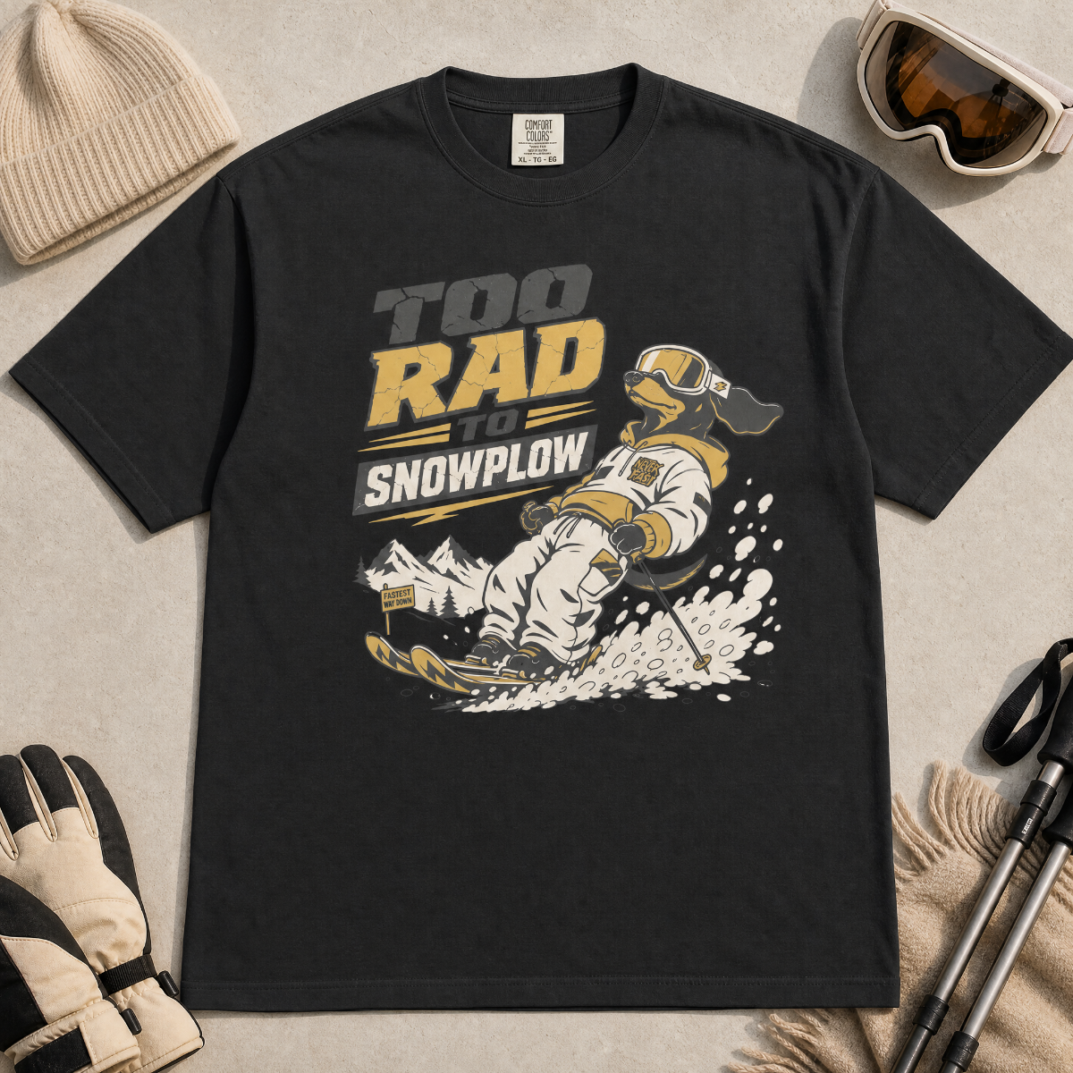 Black t-shirt with a graphic of a dachshund snowplowing and text 'Too Rad to Snowplow' on a plain background.