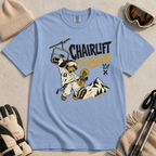 Washed denim blue t-shirt with a graphic design featuring a dachshund snowboarder and 'Chairlift Delinquent' text, surrounded by winter accessories.