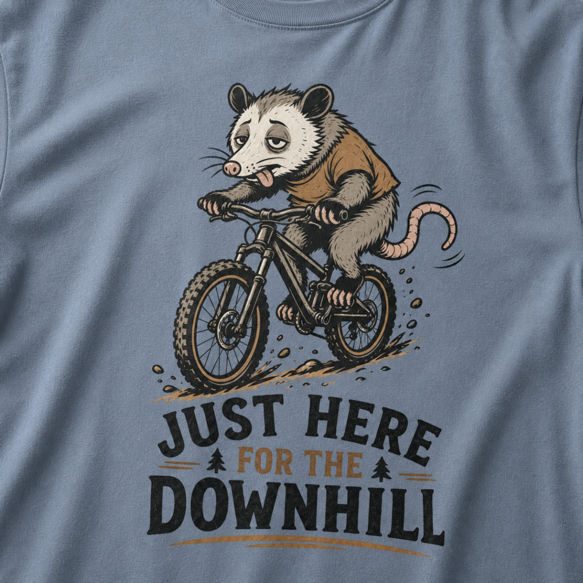 Blue jean colored t-shirt with an opossum riding a bike graphic and text 'Just Here for the Downhill'.