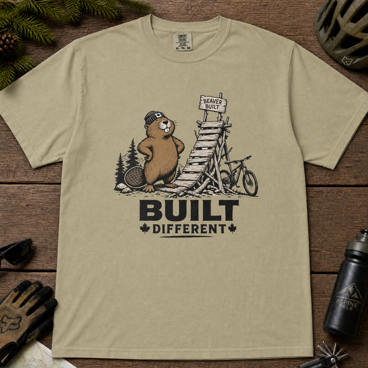 Khaki colored t-shirt with beaver graphic and 'Built Different' text.