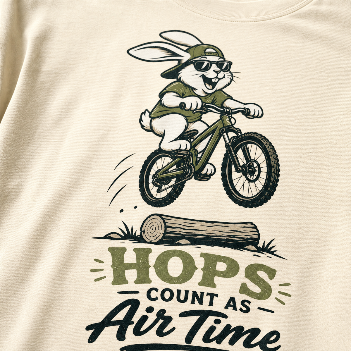 Ivory white t-shirt with a graphic of a rabbit riding a bike and text 'HOPS COUNT AS AIR TIME'.