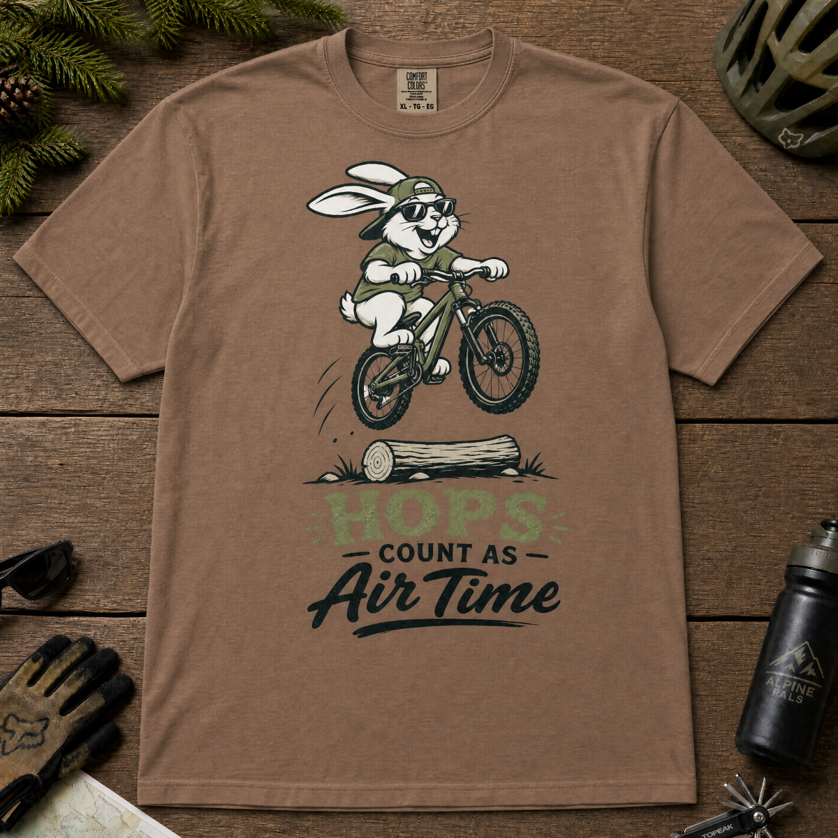 Espresso brown t-shirt with a graphic of a rabbit riding a bike and text 'HOPS COUNT AS AIR TIME'.