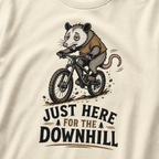 Ivory white t-shirt with an opossum riding a bike graphic and text 'Just Here for the Downhill'.