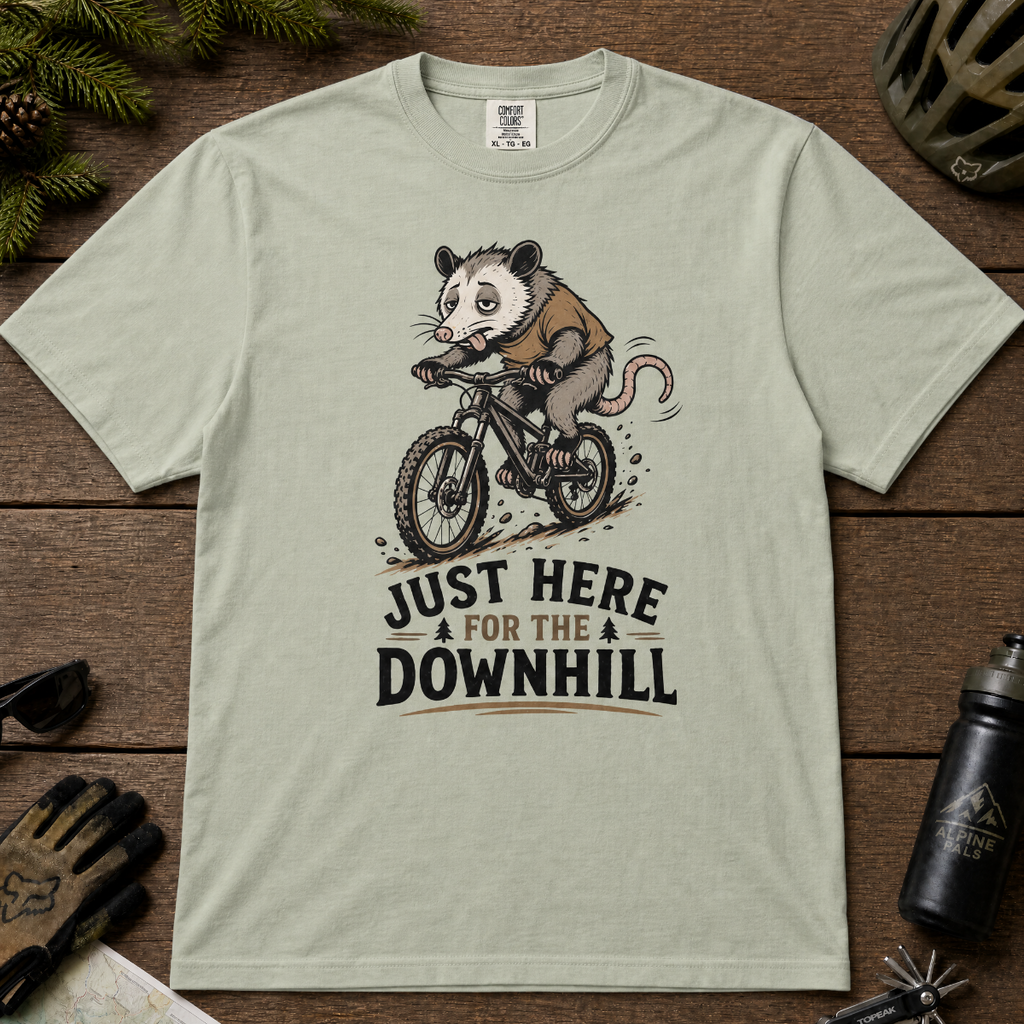 Bay green t-shirt with an opossum riding a bike graphic and text 'Just Here for the Downhill'.