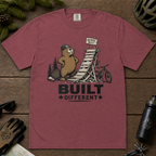 Brick red t-shirt with beaver graphic and 'Built Different' text on a white background