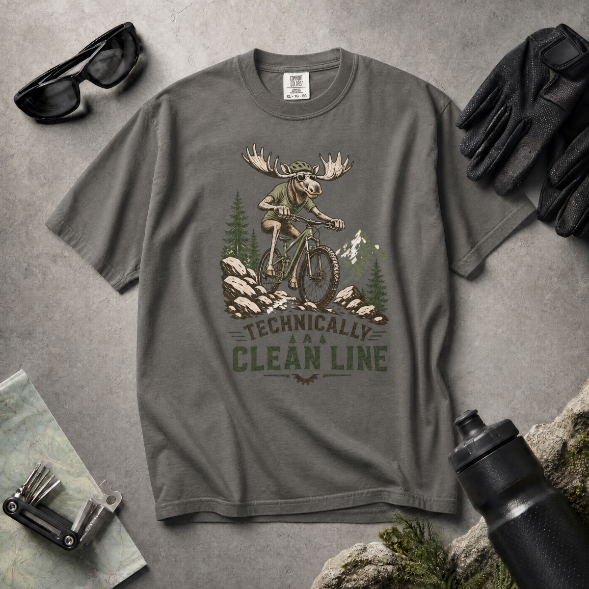 Pepper gray t-shirt with a moose riding a bike graphic and 'Technically Clean Line' text on a light gray background.