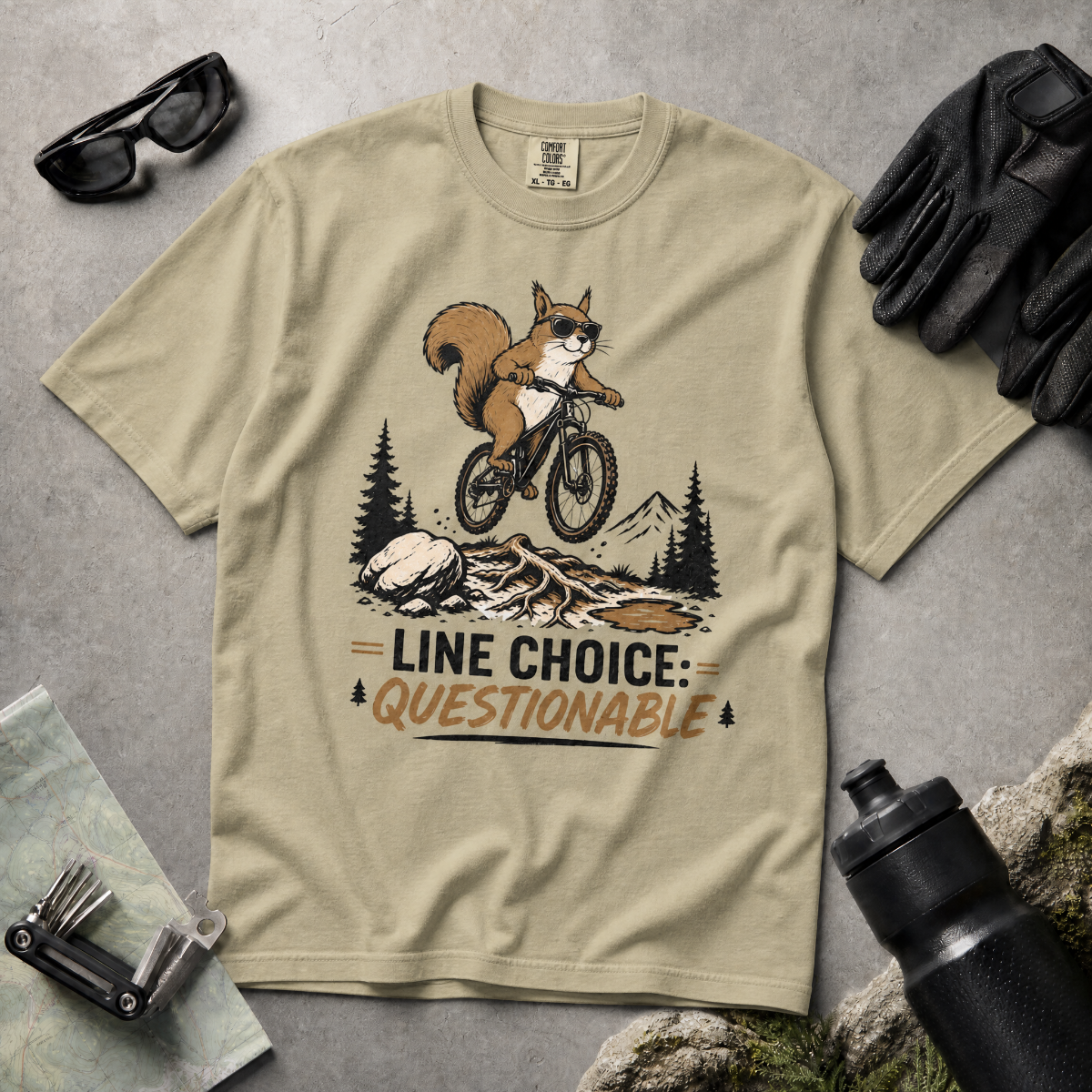 Khaki colored t-shirt with a graphic of a squirrel on a bike and text 'Line Choice: Questionable'.