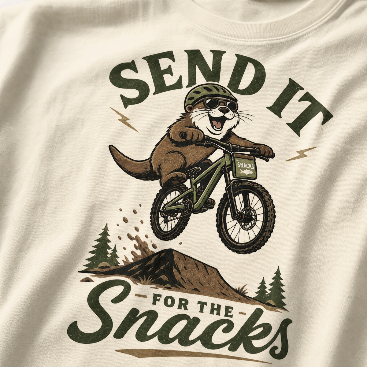 Ivory white t-shirt with graphic of an otter on a bike and text 'Send it for the snacks'.